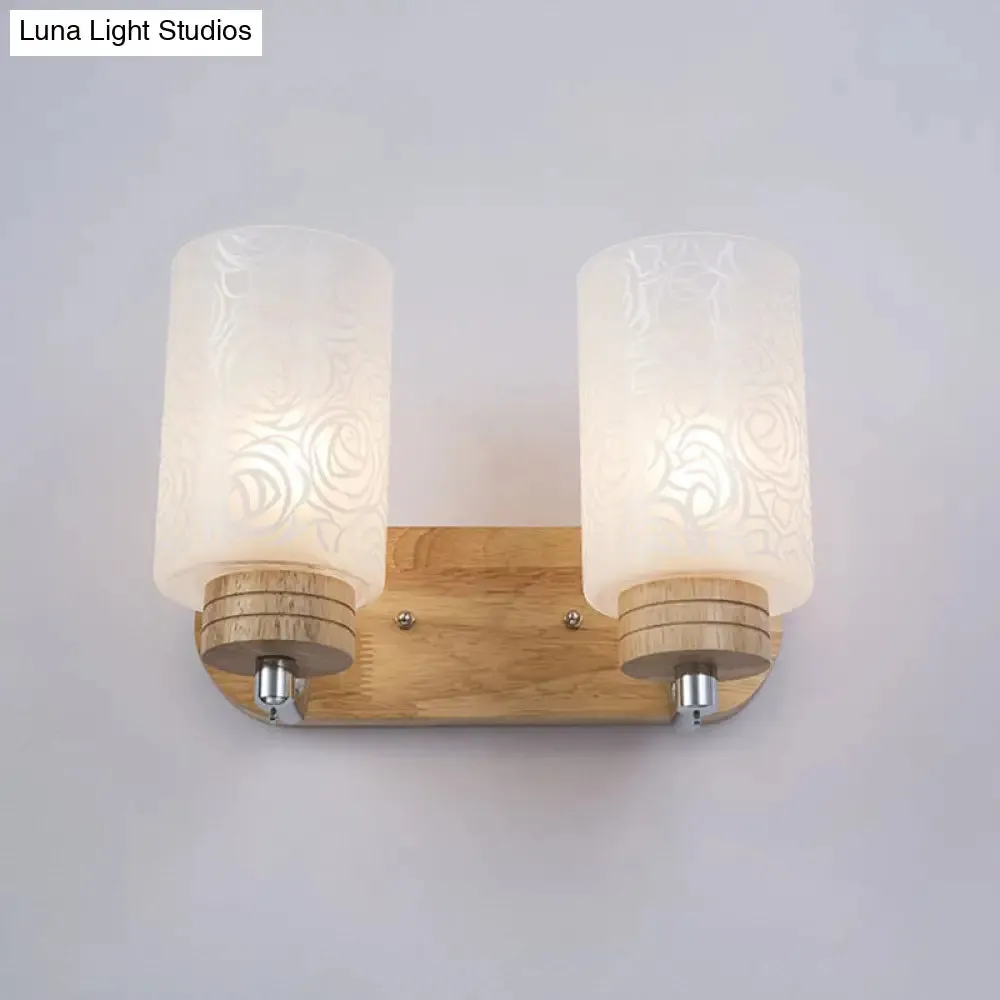Modern 2-headed White Glass Cylinder Wall Sconce with Wood Wall Mount and Rose Pattern